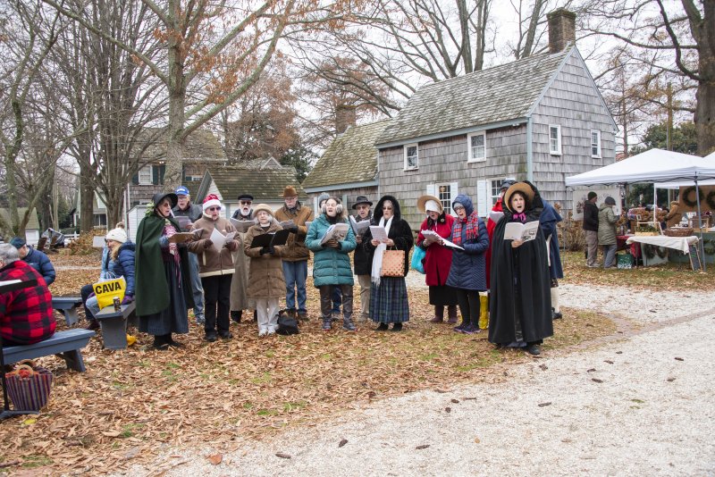 Carolers gather on the grounds at the Shipcarpenter Street campus.